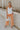 Full body view of female model wearing the Kennedy Apricot Orange Wide Leg Pants which features Orange Denim Stretch Fabric, Cropped Wide Pant Leg, Front Zipper with Button Closure, Belt Loops, Two Front Pockets andTwo Back Pockets