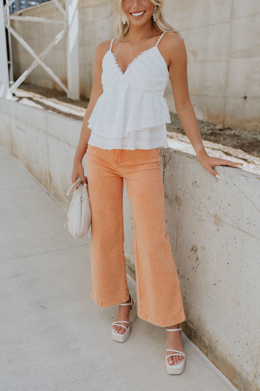 Front view of female model wearing the Kennedy Apricot Orange Wide Leg Pants which features Orange Denim Stretch Fabric, Cropped Wide Pant Leg, Front Zipper with Button Closure, Belt Loops, Two Front Pockets andTwo Back Pockets