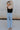 full body back view of female model wearing the Leigh Square Neckline Sleeveless Tank which features Ribbed Lightweight Fabric, Square Neckline and Sleeveless. the tank is available in white and black.