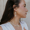 Side view of model wearing the Rowan Gold Earrings.