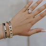 A hand is shown wearing the Beck Chain Bangle on the wrist.