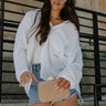 Front view of female model wearing the Alaina White Front Button-Up Long Sleeve Top which features White Lightweight Fabric, Front Button-Up Closure, Left Front Chest Pocket, Collared Neckline and Long Sleeves with Buttoned Cuffs