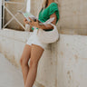 Full body view of female model wearing the Leia Green Knit Ruffle Short Sleeve Top which features  Kelly Green Knit Fabric, Ruffle Details,  Scalloped V-Neckline and Short Sleeves with Ruffle Layer Hem