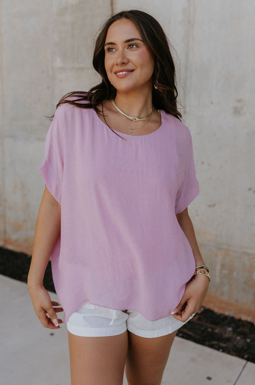 Front view of female model wearing the Haisley Pink Mauve Short Sleeve Top which features Pink Mauve Lightweight Fabric,  Pink Mauve Lining, Round Neckline and Short Sleeves