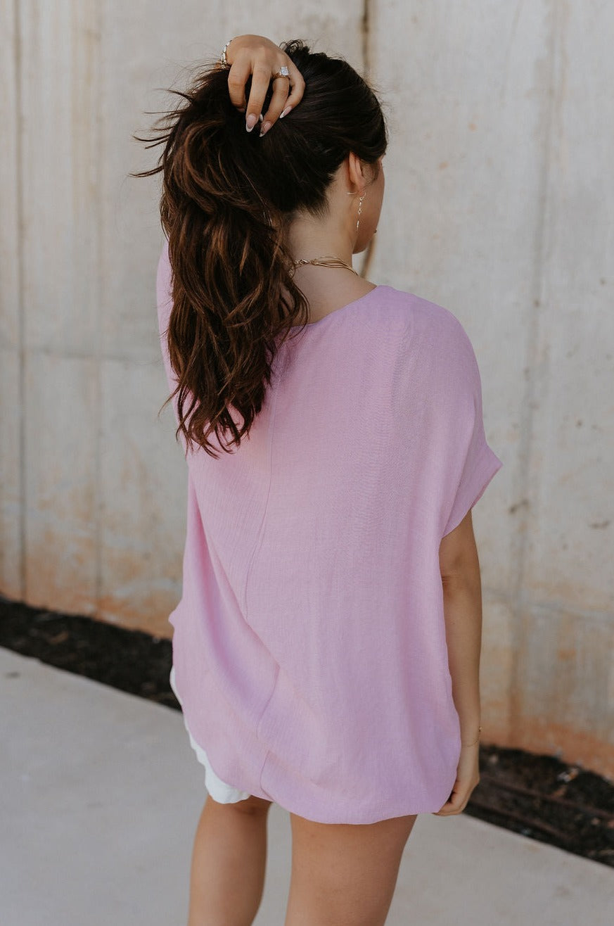 Back view of female model wearing the Haisley Pink Mauve Short Sleeve Top which features Pink Mauve Lightweight Fabric, Pink Mauve Lining, Round Neckline and Short Sleeves