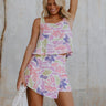 front view of female model wearing the Skye Pink Multi Floral Tank which features Pink, Purple and Peach Floral Print, Cropped Waist, Square Neckline, Back Cut-Out Design and Sleeveless