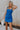 Front view of female model wearing the Grace Side Ruched Square Neckline Mini Dress which features Lightweight Linen Fabric, Fully Lined, Mini Length, Square Neckline, Ruched Side Detail, Adjustable Straps and Monochrome Back Zipper with Hook Closure. the dress is available in blue and white