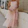 Full body view of female model wearing the Evie Peach Blush Floral Tiered Midi Dress which features Light Peach Sheer Fabric, Floral Print, Tiered Design, Midi Length,  Light Peach Lining, Square Neckline, Tie Straps and Smocked Back