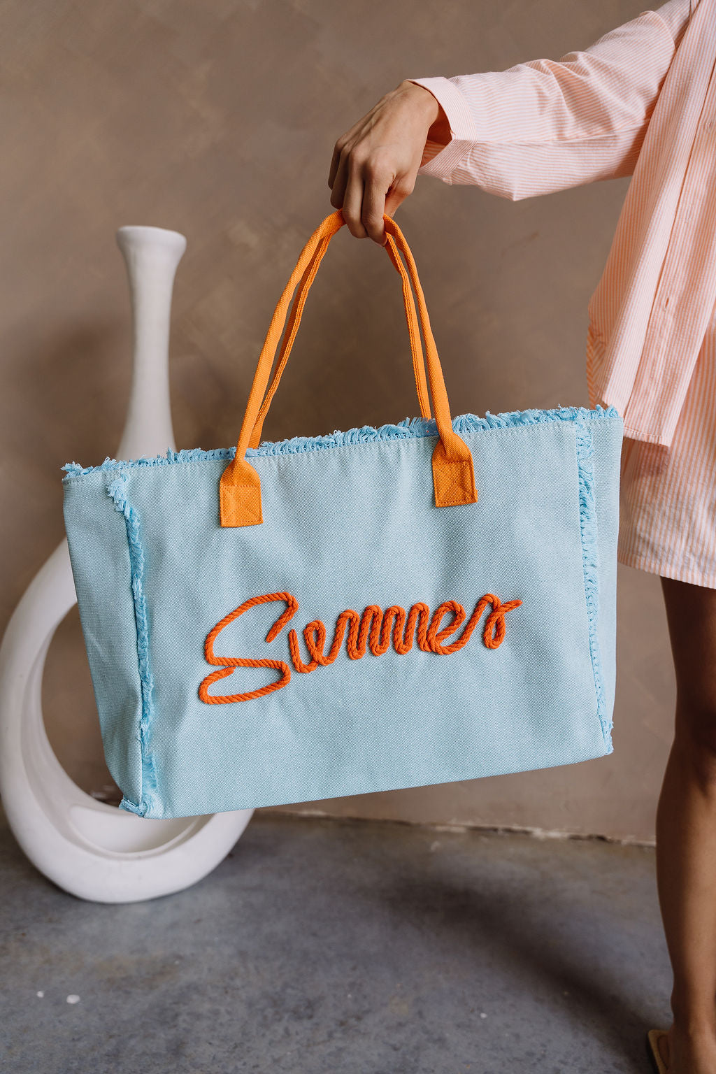 Summer Aqua & Orange Tote Bag - front view held by model