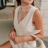 front view of female model wearing the Trisha Lace High Neckline Tank which features sheer lace fabric, lettuce trim, slight high neckline and sleeveless. the tank is available in black and cream.