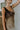 side view of female model wearing the Franceska Taupe Ombre Satin Midi Dress which features Brown Ombre Satin Fabric, Midi Length, Sleeveless, Black Thigh Length Lining and Cowl Neckline