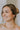 Side view of female model wearing the Katie Gold & Pearl Scoop Studs that have gold scoop studs with small pearl polka dots