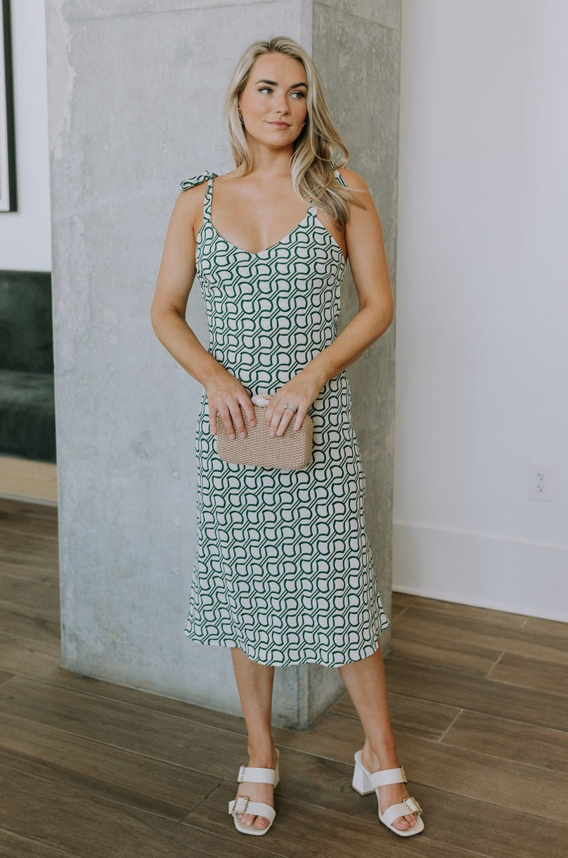 Full body view of female model wearing the Selena Green & Cream Tie Straps Midi Dress which features Green and Cream Lightweight Fabric, Geometric Pattern, Midi Length, Sweetheart Neckline and Tie Straps