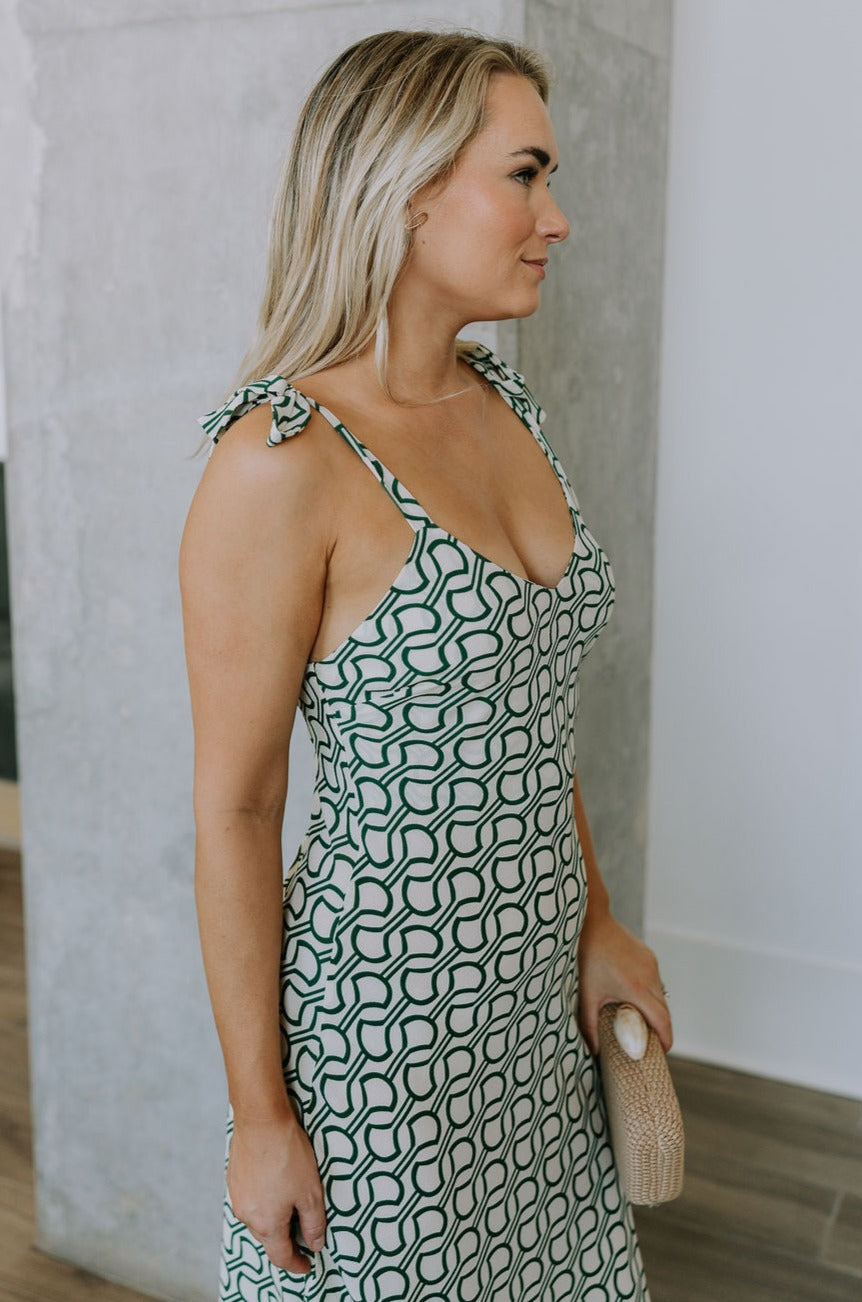 side view of female model wearing the Selena Green & Cream Tie Straps Midi Dress which features Green and Cream Lightweight Fabric, Geometric Pattern, Midi Length, Sweetheart Neckline and Tie Straps