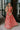 Full body view of female model wearing the Adalyn Pink & Red Paisley Cut-Out Maxi Dress which features Red, Pink and Peach Paisley Print, Side Ruffle Slits, Peach Thigh Length Lining, Maxi Length, Elastic Waistband, Side Cutouts with Rattan Buckle, Plunge Neckline, Ruffle Straps andTie Back Closure