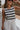 close up view of female model wearing the Mallory Off White & Black Stripe Tank which features White and Black Stripe Pattern, Round Neckline, Cropped Waist and Sleeveless