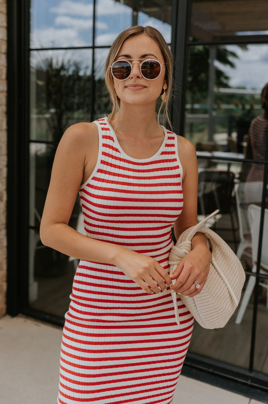Upper body front view of female model wearing the Delilah Red & White Striped Midi DressDelilah Red & White Striped Midi Dress that has horizontal red and white stripes, a round neck, sleeveless, and midi hem.