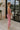 Full body side view of female model wearing the Delilah Red & White Striped Midi DressDelilah Red & White Striped Midi Dress that has horizontal red and white stripes, a round neck, sleeveless, and midi hem.