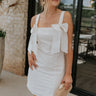 Full body view of female model wearing the Diana White Bow Straps Mini Dress which features White Cotton Fabric, White Lining, Mini Length, Square Neckline, Bow Details, Thick Straps and Monochrome Back Zipper with Hook Closure