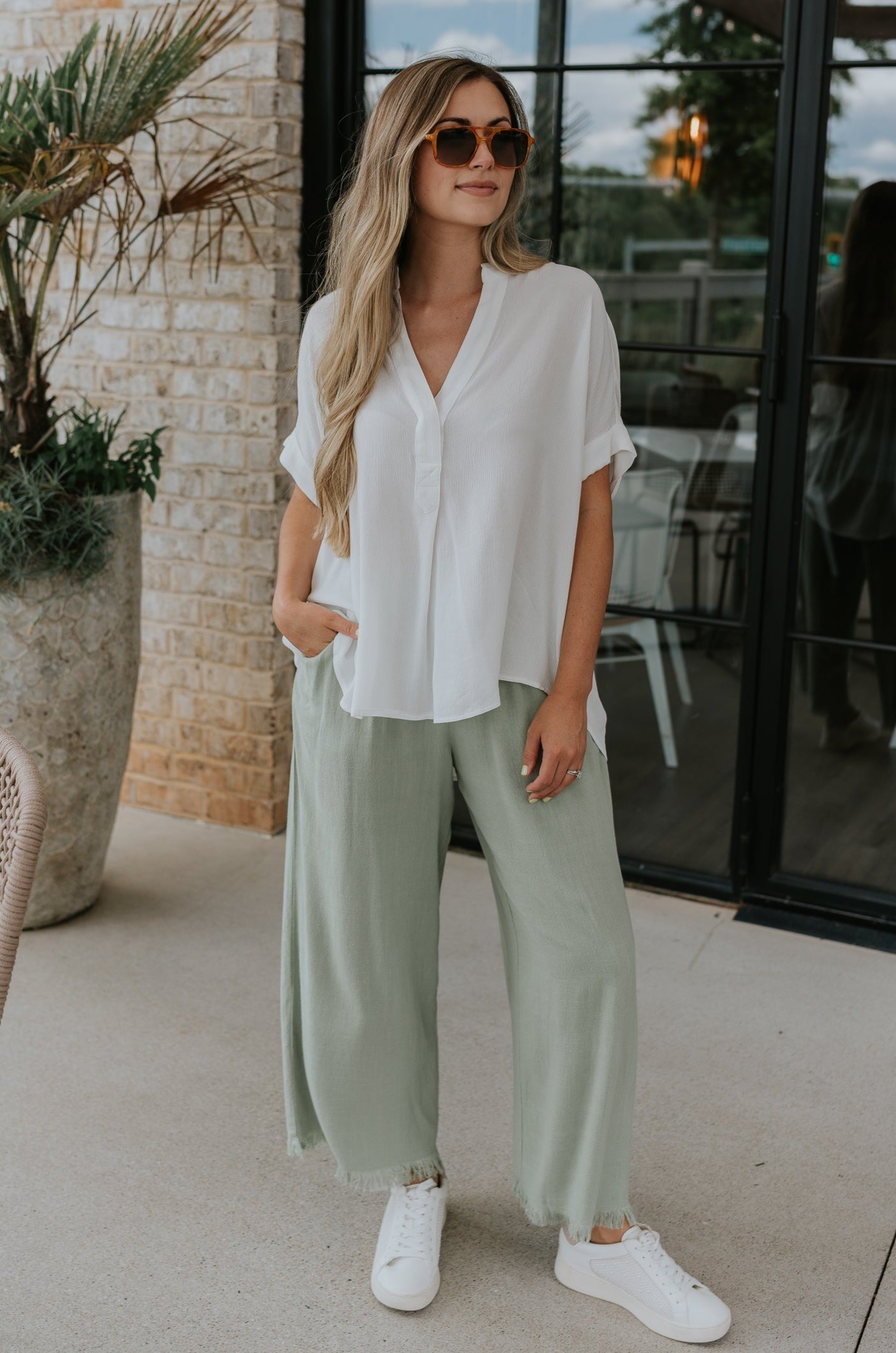 Full body view of female model wearing the Evie White Short Sleeve Button-Up Top which features Evie White Short Sleeve Button-Up Top