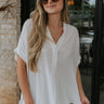 front view of female model wearing the Evie White Short Sleeve Button-Up Top which features Evie White Short Sleeve Button-Up Top