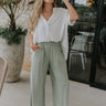 Full body view of female model wearing the Leona Linen Fray Cropped Pants which features Lightweight Fabric, Wide Cropped Leg, Fray Hem Details, Two Front Pockets and Elastic Waistband. the pants are available in blue, green and white.