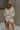 Full body view of female model wearing the Andrea Ecru Button-Up Top which features Ecru Cotton Fabric, Monochrome Button-Up Top, Collared Neckline, Front Left Chest Pocket and Short Sleeves