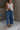 front view of female model wearing the Leona Linen Fray Cropped Pants which features Lightweight Fabric, Wide Cropped Leg, Fray Hem Details, Two Front Pockets and Elastic Waistband. the pants are available in blue, green and white.