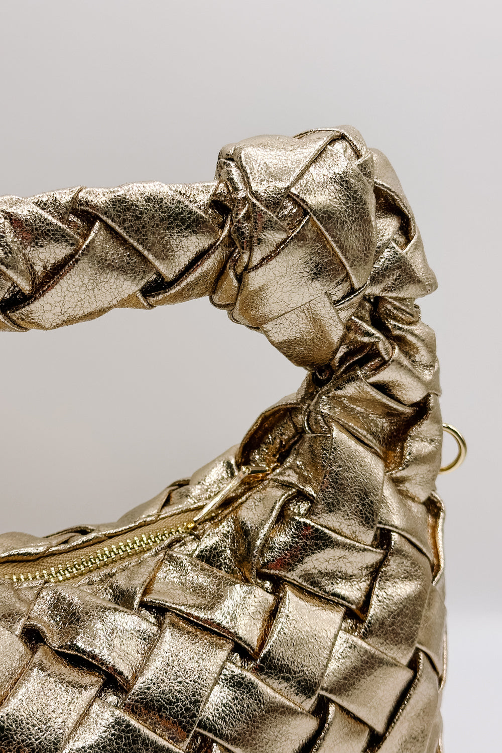 close up view of the Josie Gold Crinkle Braid Purse which features gold crinkle fabric, braided purse and zipper closure