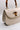 Image shows the Allison Ivory Wooden Bamboo Strap Purse which features  ivory leather, wooden bamboo strap and knob closure, black lining and gold hardware details