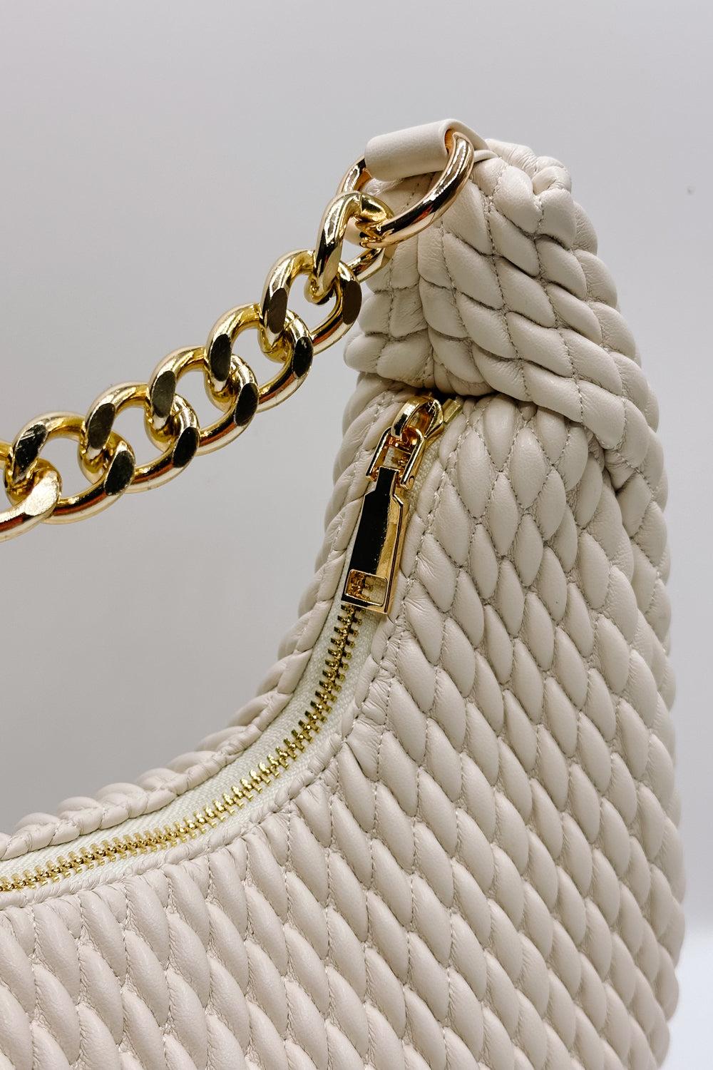 Front view of the Jade Cream & Gold Chain Strap Purse which features cream woven design fabric, black lining, gold chain strap and gold zipper closure