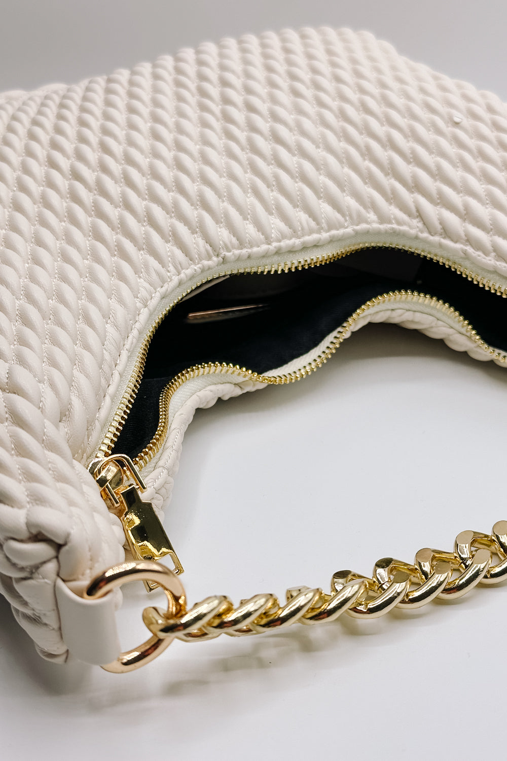 Front view of the Jade Cream & Gold Chain Strap Purse which features cream woven design fabric, black lining, gold chain strap and gold zipper closure