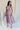 Full body view of female model wearing the Ellie Dusty Purple Floral Midi Dress which features Dusty Mauve Lightweight Fabric, Dusty Mauve Lining, Floral Print, Midi Length, Elastic Waistband, V Neckline and Short Sleeves