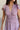 front view of female model wearing the Ellie Dusty Purple Floral Midi Dress which features Dusty Mauve Lightweight Fabric, Dusty Mauve Lining, Floral Print, Midi Length, Elastic Waistband, V Neckline and Short Sleeves