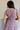 back view of female model wearing the Ellie Dusty Purple Floral Midi Dress which features Dusty Mauve Lightweight Fabric, Dusty Mauve Lining, Floral Print, Midi Length, Elastic Waistband, V Neckline and Short Sleeves