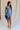 Full body view of female model wearing the Azlynn Blue Satin Cowl Neckline Dress which features Blue Satin Fabric, Overlay Hem Detail, Ruched Detail, Cowl Neckline with Adjustable Straps and Side Monochrome Zipper with Hook Closure