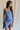 front view of female model wearing the Azlynn Blue Satin Cowl Neckline Dress which features Blue Satin Fabric, Overlay Hem Detail, Ruched Detail, Cowl Neckline with Adjustable Straps and Side Monochrome Zipper with Hook Closure