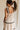 back view of female model wearing the Clara Ecru & Black Wavy Trim Midi Dress which features Cream Lightweight Fabric, Cream Lining, Midi Length, Pockets on each side, Black Wavy Trim Details, Square Neckline, Straps and Smocked Back