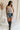 Full body view of female model wearing the Lainey Natural & Black Stitch Tank which features Cream Open Knit Fabric, Round Neckline, Sleeveless and Black Criss Cross Stitch Details