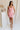 Full body view of female model wearing the Eliza Pink Square Neckline Mini Dress which features Lightweight Pink Fabric, Pink Lining, Mini Length, Square Neckline, Sleeveless and Monochrome Back Zipper with Hook Closure