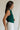 side view of female model wearing the Reign Hunter Green Buttoned Vest which features Hunter Green Lightweight Fabric, Monochrome Button Up, Collared Neckline and Sleeveless