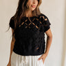 front view of female model wearing the Colette Black Cut-Out Short Sleeve Top which features Black Lightweight Knit Fabric, Cutout Details, Round Neckline and Short Sleeves