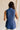 back view of female model wearing the Faye Blue Buttoned Vest which features Blue Lightweight Fabric, Monochrome Button Closure, Collared Neckline and Sleeveless