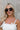 Regan Sunglasses in Black & Gold - front view on model