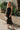 Full body view of female model wearing the Mila Black Knit Cut-Out Trim Midi Dress which features Black Knit Fabric, Square Neckline, Straps and Cutout Details