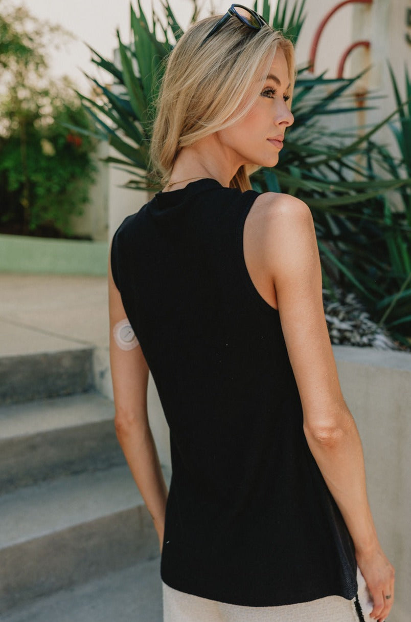 Back view of Lydia Button Up Tank in Blackthat is sleeveless with tortoise buttons and a deep V neckline.