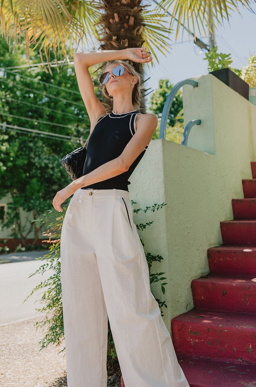 Full body front view of Ashley Halter Tank in black with white trim, ribbed sleeveless tank with halter neckline.