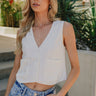 Front view of female model wearing the Londyn Off White Button-Up Vest which features White Textured Fabric, Monochrome Button Up, Two Front Pockets, V-Neckline and Sleeveless