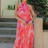 Up close front view of Josephine Multicolor Printed Halter Maxi Dress that is red orange, pink, and purple, with a halter neckline, geometric pattern, sleeveless.