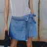 Close up of Molly Medium Wash Denim Skort that has braid details across and a cute tie on the side.